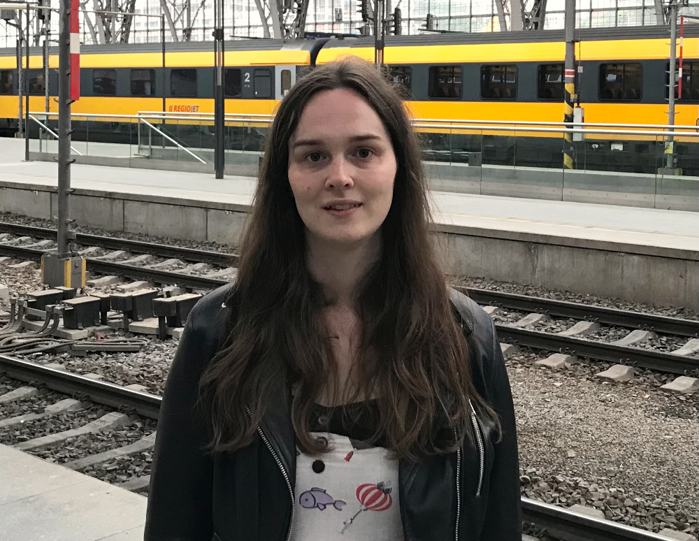 Jessica Tallon standing in front of some trains